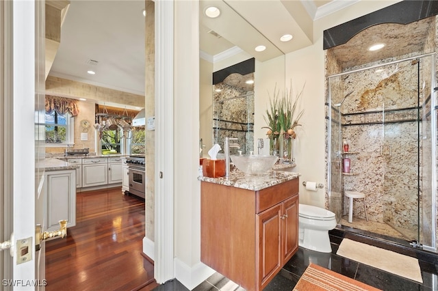 full bathroom featuring vanity, crown molding, and a stall shower