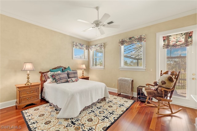 bedroom featuring visible vents, wood-type flooring, ornamental molding, and access to outside