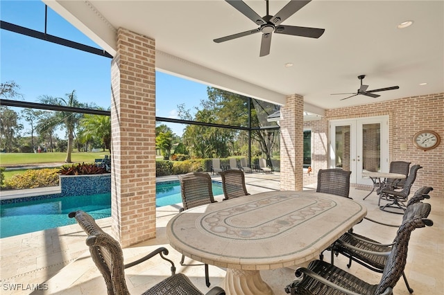 view of patio featuring an outdoor pool, french doors, a ceiling fan, and glass enclosure