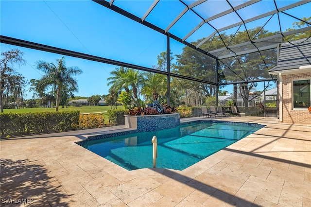 pool featuring glass enclosure and a patio area