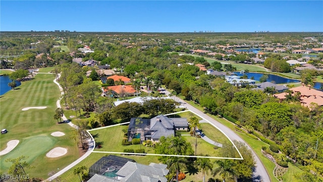 drone / aerial view with view of golf course and a water view