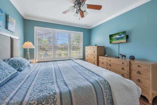 bedroom featuring crown molding, wood finished floors, and ceiling fan