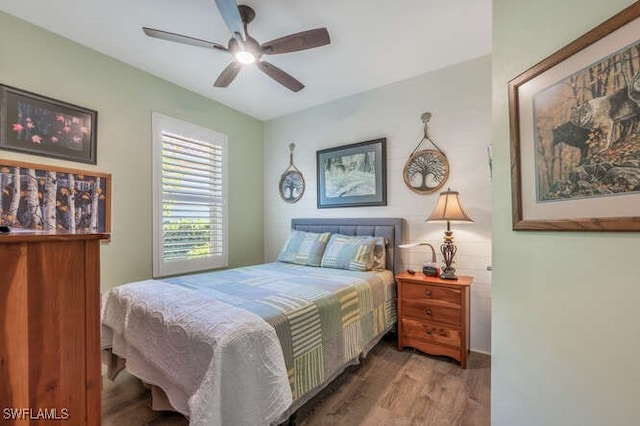 bedroom with a ceiling fan and wood finished floors