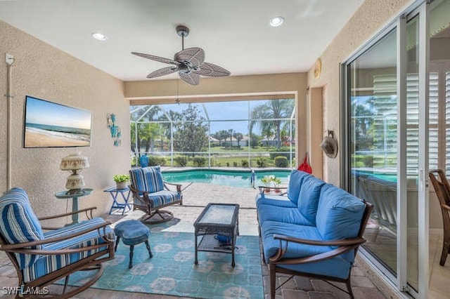 view of patio featuring a lanai, an outdoor hangout area, an outdoor pool, and ceiling fan