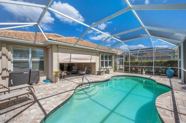 outdoor pool featuring a patio and a lanai