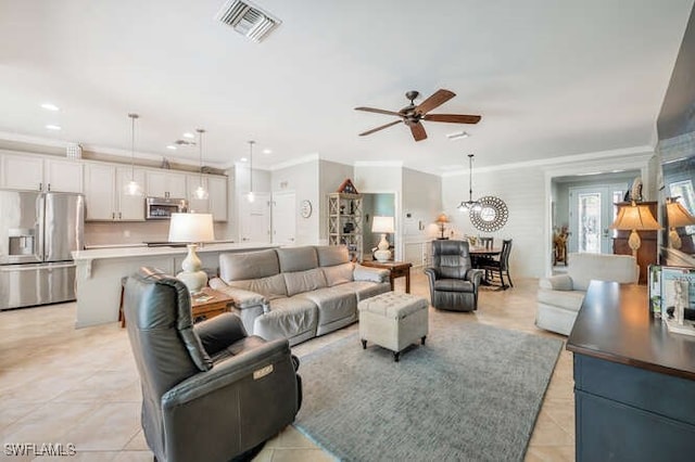 living room featuring light tile patterned floors, visible vents, recessed lighting, ornamental molding, and ceiling fan with notable chandelier