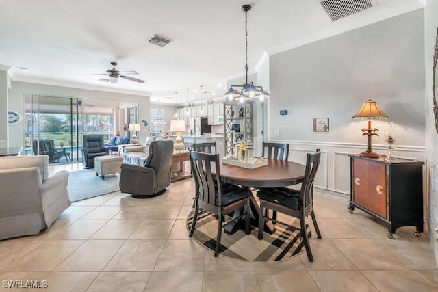 dining area with light tile patterned floors, ceiling fan with notable chandelier, and visible vents