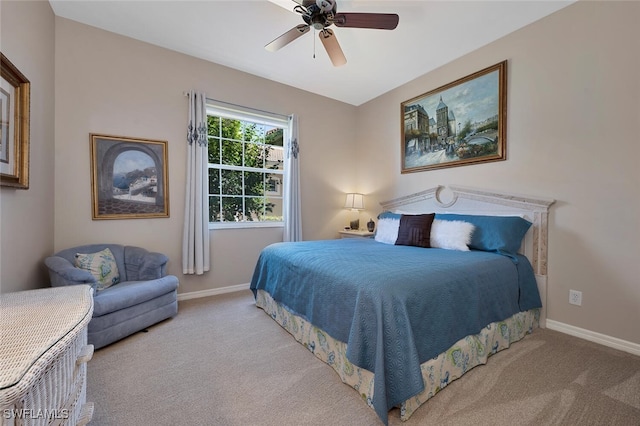 bedroom with a ceiling fan, baseboards, and carpet floors