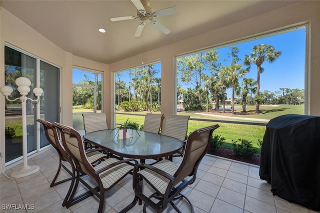 sunroom with plenty of natural light and a ceiling fan