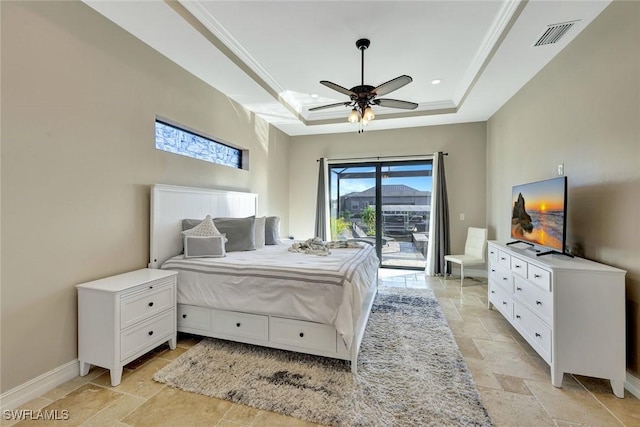 bedroom with stone tile floors, baseboards, access to exterior, crown molding, and a raised ceiling