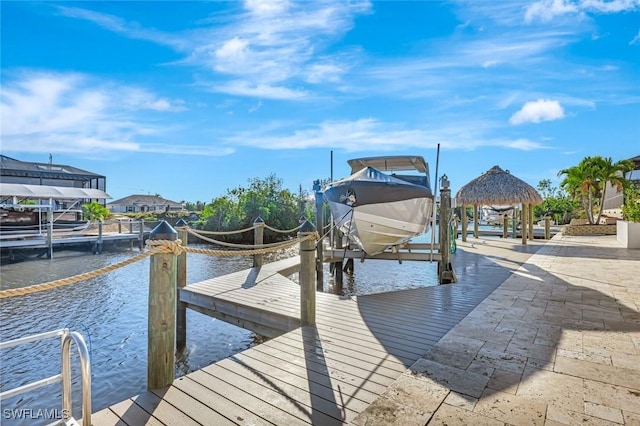 view of dock with boat lift and a water view