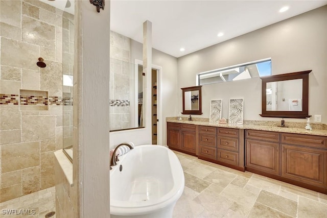 full bath featuring double vanity, walk in shower, recessed lighting, and a freestanding bath