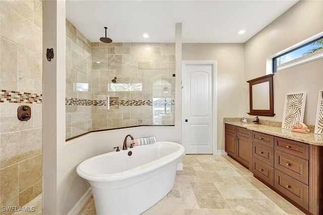 bathroom with baseboards, a freestanding bath, vanity, and walk in shower