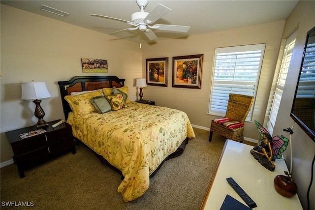 carpeted bedroom featuring visible vents, baseboards, and ceiling fan