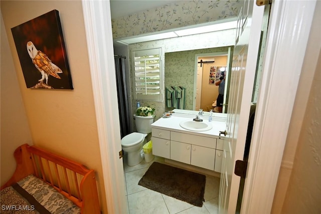 bathroom featuring wallpapered walls, toilet, tile patterned floors, vanity, and curtained shower