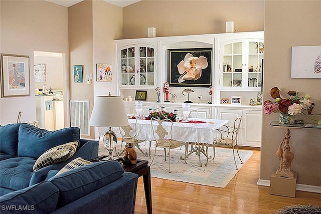 dining area featuring visible vents and wood finished floors