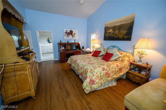 bedroom with dark wood-style floors, high vaulted ceiling, ensuite bathroom, and a ceiling fan