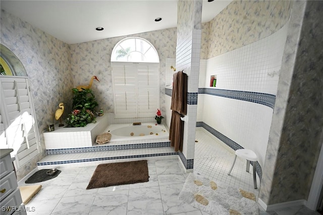 full bathroom featuring wallpapered walls, a jetted tub, marble finish floor, and walk in shower