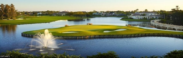 view of property's community with golf course view and a water view
