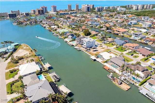 birds eye view of property with a view of city and a water view