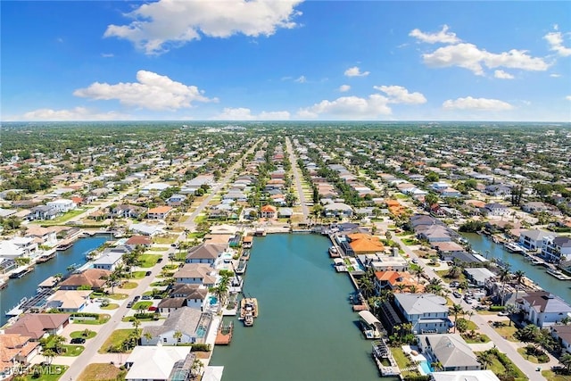 drone / aerial view featuring a residential view and a water view