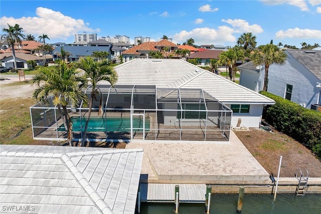 rear view of property with a patio, an outdoor pool, a residential view, and a lanai