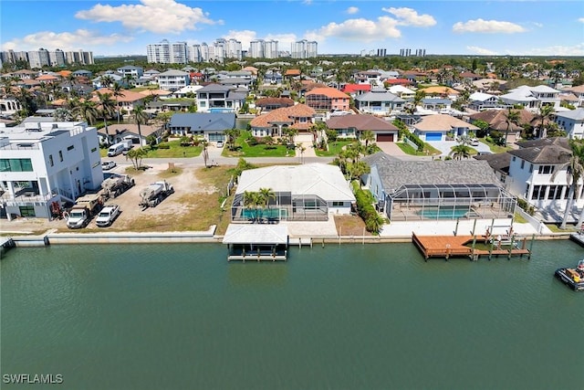 drone / aerial view with a residential view and a water view