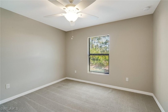 unfurnished room featuring baseboards, light carpet, and ceiling fan