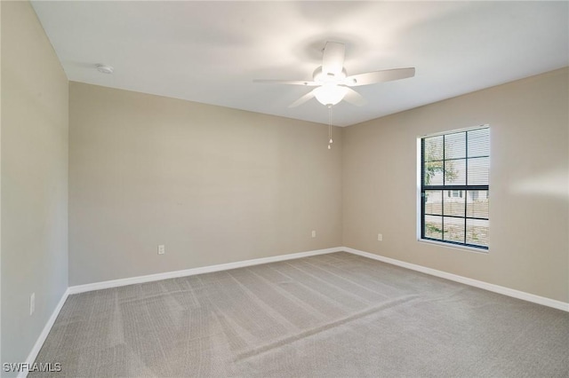 empty room with baseboards, carpet floors, and a ceiling fan