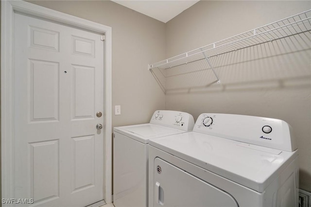 laundry room with laundry area and washing machine and clothes dryer