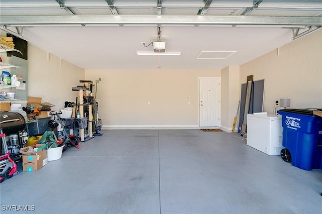 garage with baseboards and a garage door opener