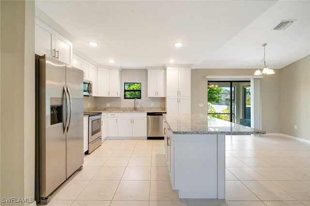 kitchen with white cabinets, visible vents, appliances with stainless steel finishes, and a center island