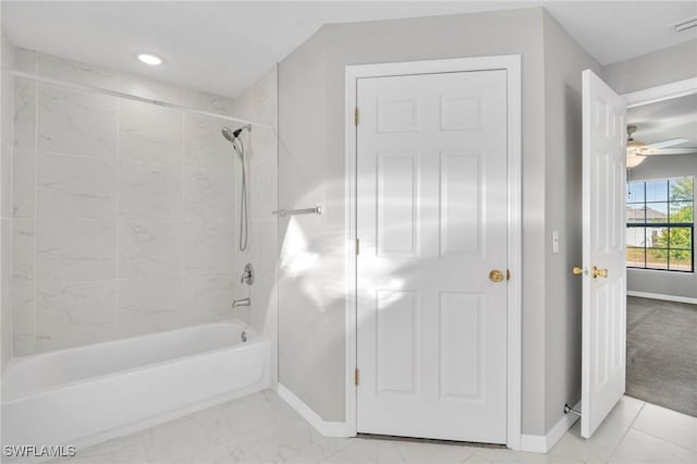 bathroom with baseboards, a ceiling fan, and shower / washtub combination