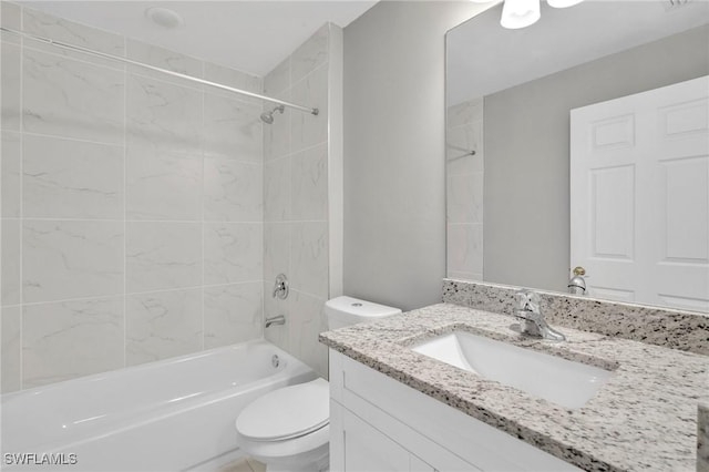 bathroom featuring toilet, shower / bathing tub combination, and vanity
