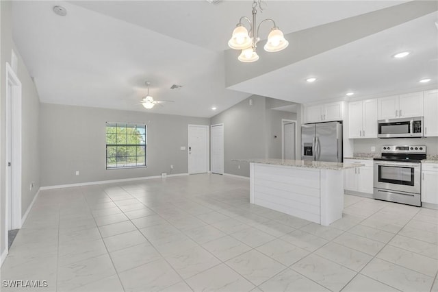 kitchen featuring recessed lighting, open floor plan, white cabinetry, a kitchen island, and appliances with stainless steel finishes