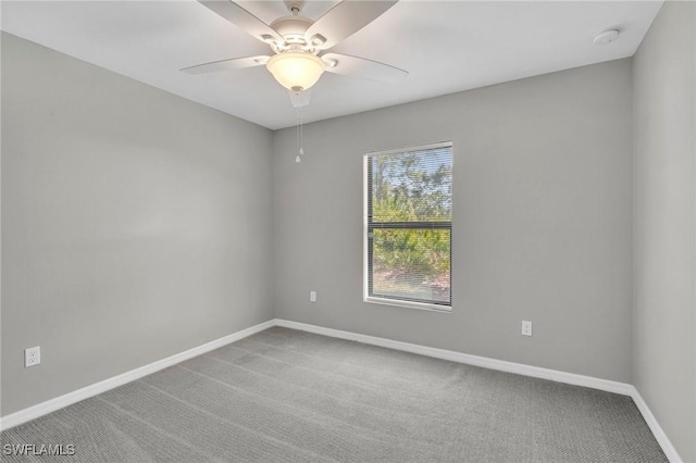 empty room with baseboards, a ceiling fan, and carpet
