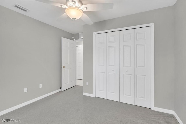 unfurnished bedroom featuring a closet, baseboards, carpet flooring, a ceiling fan, and visible vents