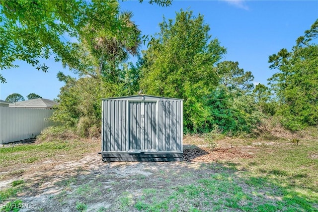 view of shed featuring fence