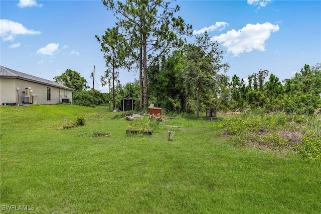 5303 4th St W, Lehigh Acres, FL 33971 - view of grassy yard with a storage unit