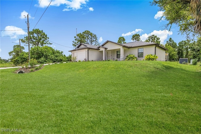 5303 4th St W, Lehigh Acres, FL 33971 - view of front of house with stucco siding, an attached garage, and a front lawn