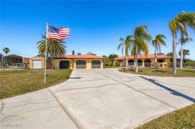 ranch-style house with concrete driveway, a tiled roof, a front lawn, and stucco siding