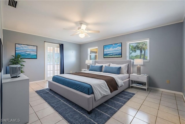 bedroom featuring light tile patterned flooring, visible vents, crown molding, and baseboards