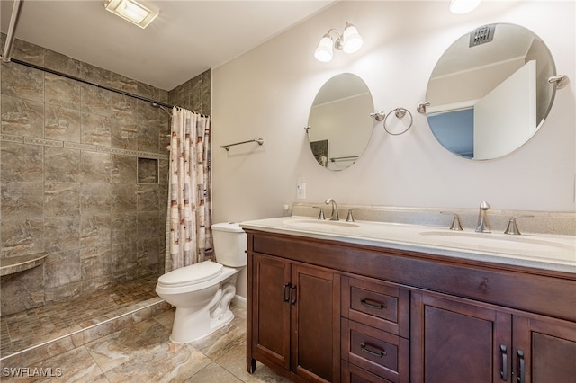 full bathroom with a sink, tiled shower, toilet, and double vanity