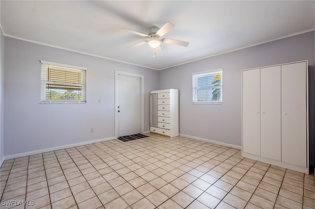 unfurnished bedroom featuring baseboards, a ceiling fan, and crown molding