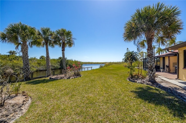 view of yard featuring a patio and a water view