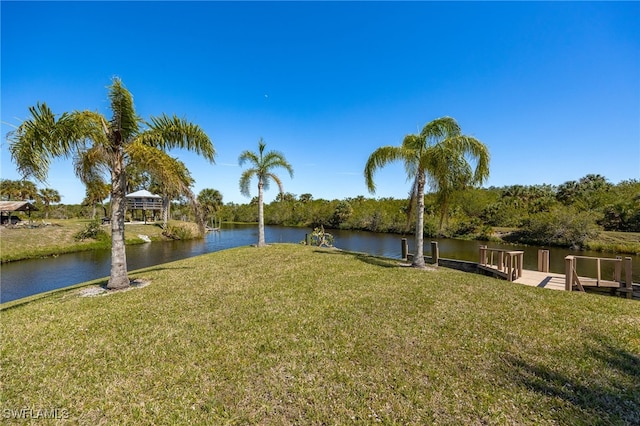 view of yard featuring a water view and a dock