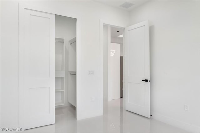 unfurnished bedroom featuring visible vents and a closet