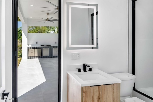 bathroom with vanity, toilet, recessed lighting, and ceiling fan