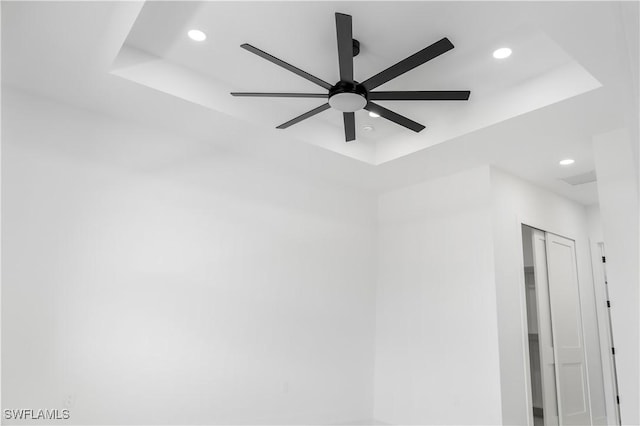 details with a ceiling fan, a raised ceiling, and recessed lighting