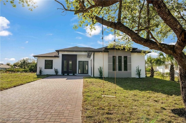 view of front of house featuring a front lawn and stucco siding